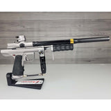 Right side USED Empire Sniper Pump Grey paintball marker with a black and silver design on a white surface with a wooden background