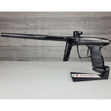Left side USED DLX Luxe IDOL Paintball Marker Black Polished on a woodgrain background