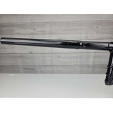 Left side barrel USED DLX Luxe IDOL Paintball Marker Black Polished on a woodgrain background