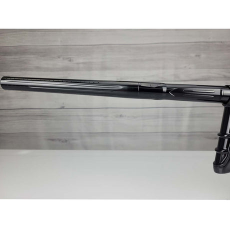 Left side barrel USED DLX Luxe IDOL Paintball Marker Black Polished on a woodgrain background