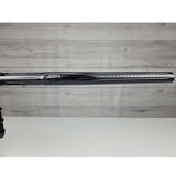 Right side barrel close up USED DLX Luxe IDOL Paintball Marker Black Polished on a woodgrain background