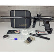 USED DLX Luxe IDOL Paintball Marker Black Polished with case and accessories on a woodgrain background