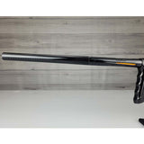 Left side barrel USED DLX Luxe TM40 Paintball Marker Black against a woodgrain background