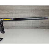 Right side barrel USED DLX Luxe TM40 Paintball Marker Black against a woodgrain background