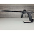 Left side USED DLX Luxe TM40 Paintball Marker Black against a woodgrain background