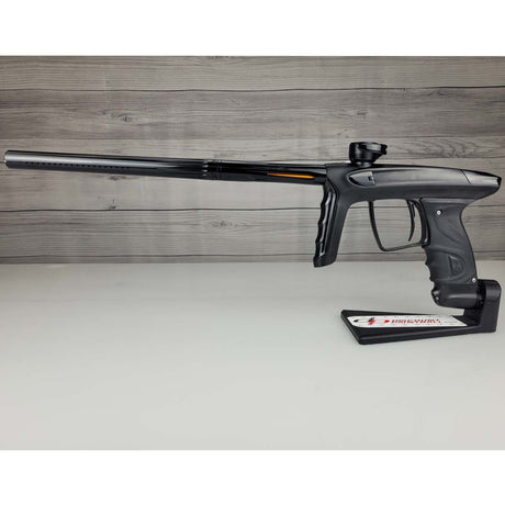 Left side USED DLX Luxe TM40 Paintball Marker Black against a woodgrain background