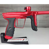 Right side body USED DLX Luxe Aire Red Polished paintball marker on a stand against a woodgrain background