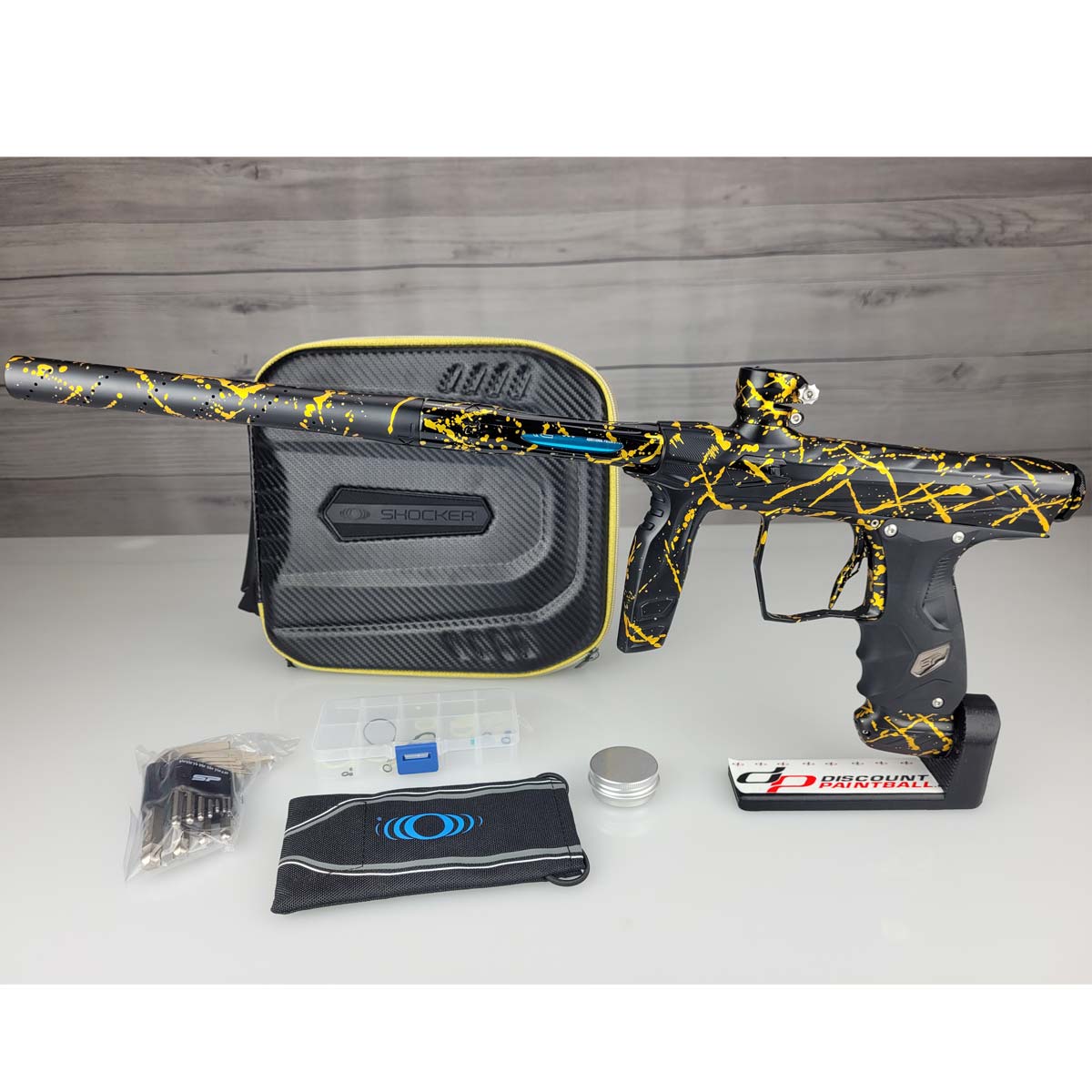 USED HK Army Shocker AMP Prestige Black Gold Splash on a woodgrain background with case and accessories