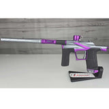 Purple and silver USED Planet Eclipse LV2 Paintball Marker Havoc Grey Purple on a white surface with a wooden background