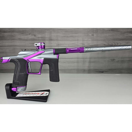 Right side Purple and silver USED Planet Eclipse LV2 Paintball Marker Havoc Grey Purple on a white surface with a wooden background