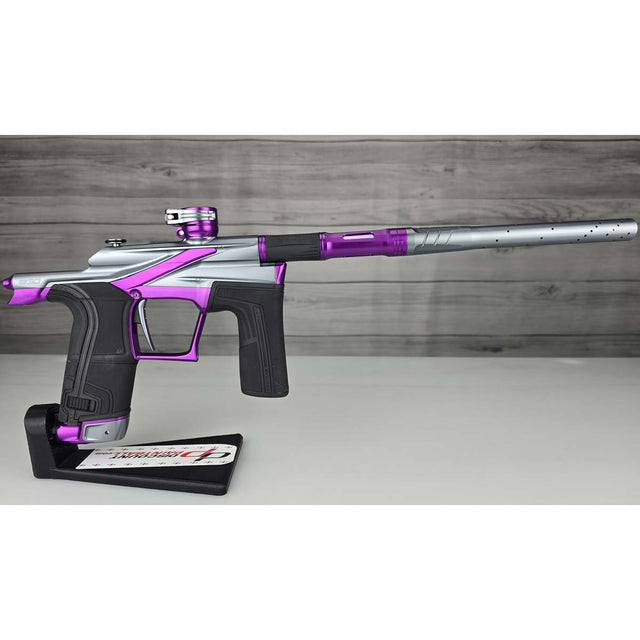 Right side Purple and silver USED Planet Eclipse LV2 Paintball Marker Havoc Grey Purple on a white surface with a wooden background