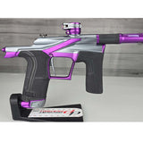Close up of right side body Purple and silver USED Planet Eclipse LV2 Paintball Marker Havoc Grey Purple on a white surface with a wooden background