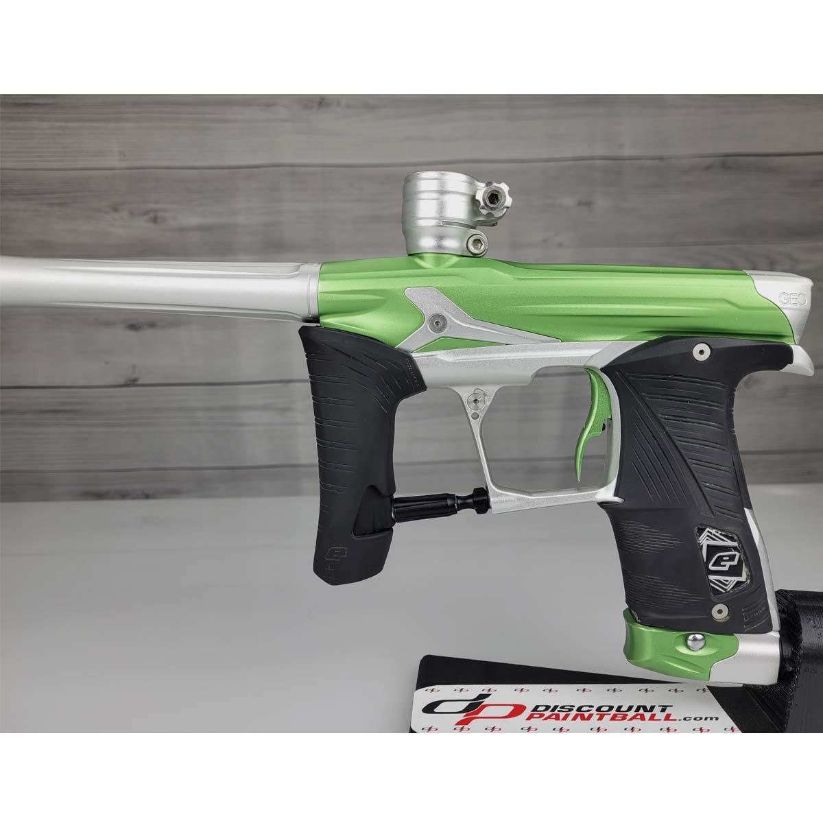 Left side body Green and silver USED Planet Eclipse Geo 3.5 Kyrpton Ice Green Silver paintball marker on a wood panel background.