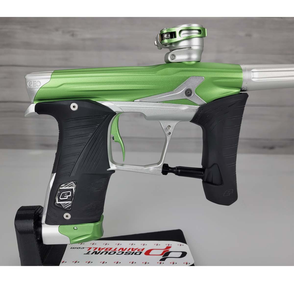 Right side body Green and silver USED Planet Eclipse Geo 3.5 Kyrpton Ice Green Silver paintball marker on a wood panel background.