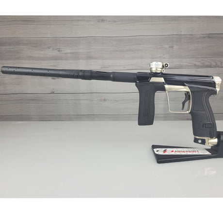 Left side USED Planet Eclipse CS2 Paintball Marker Black Sandstone on a white surface and wooden background
