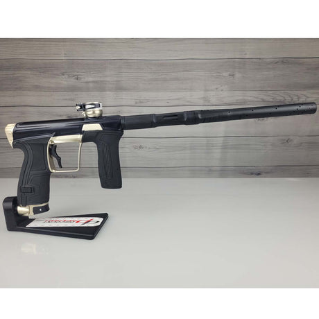 Right side USED Planet Eclipse CS2 Paintball Marker Black Sandstone on a white surface and wooden background