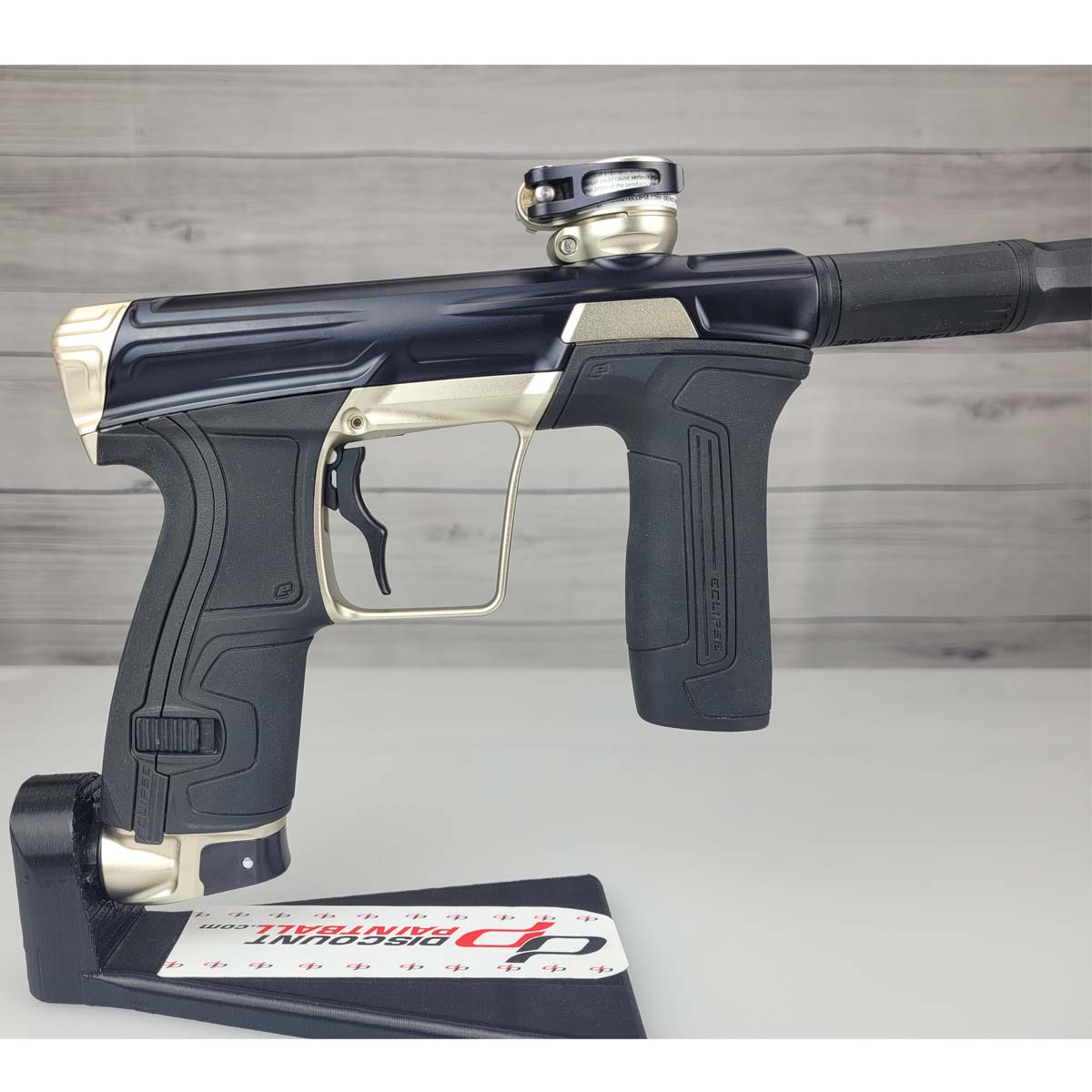 Right side body USED Planet Eclipse CS2 Paintball Marker Black Sandstone on a white surface and wooden background