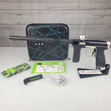 USED Planet Eclipse CS2 Paintball Marker Black Sandstone with accessories on a white surface and wooden background