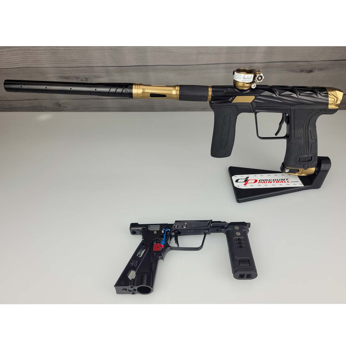 Black and gold USED Planet Eclipse Infamous CS3 paintball marker with a separate right side black Mech frame on a white surface.