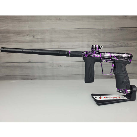Left side USED Planet Eclipse CS2 Paintball Marker Black Purple Grey Splash in a marker stand on a woodgrain background