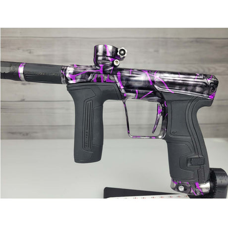 Left side body USED Planet Eclipse CS2 Paintball Marker Black Purple Grey Splash on a woodgrain background