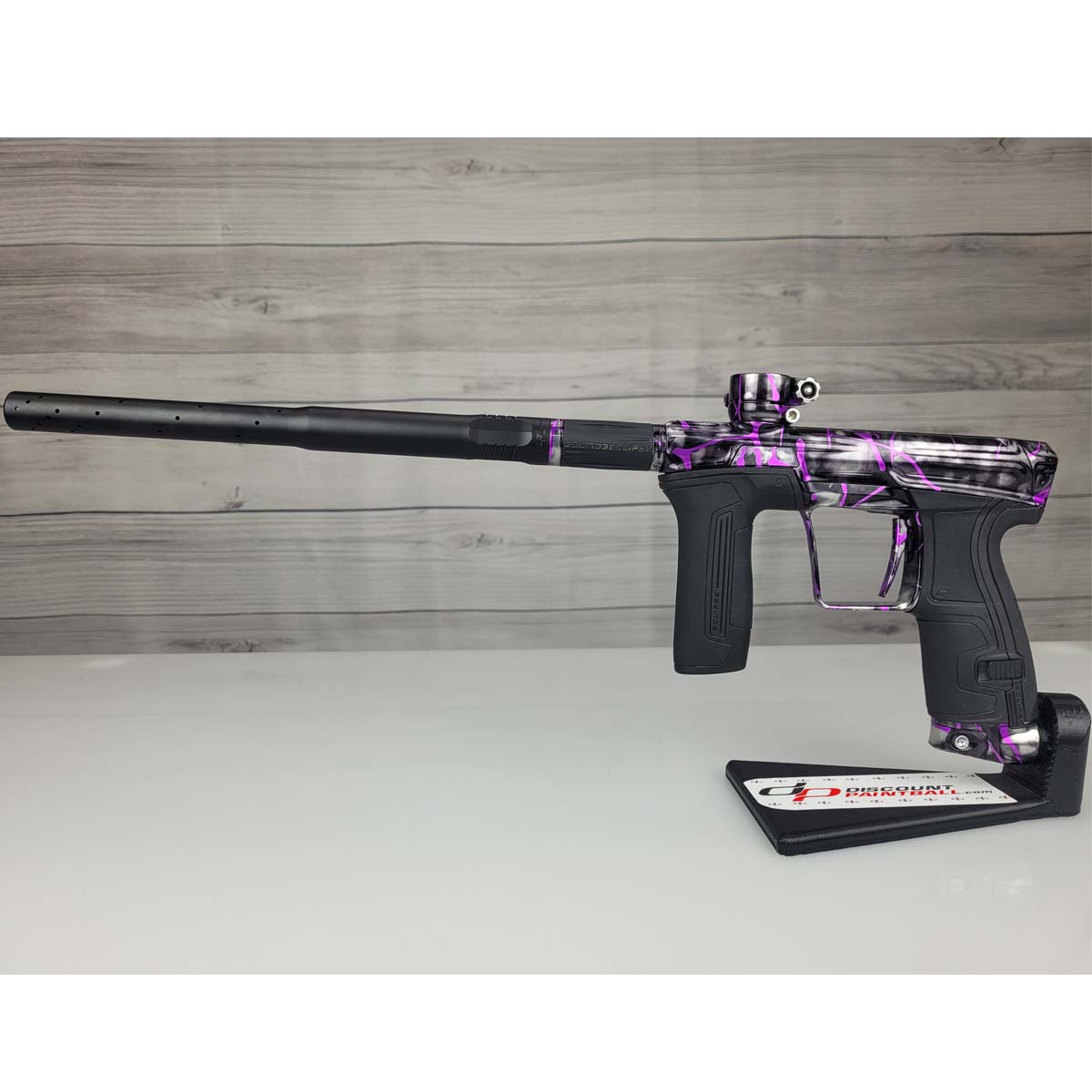 Left side USED Planet Eclipse CS2 Paintball Marker Black Purple Grey Splash on a woodgrain background