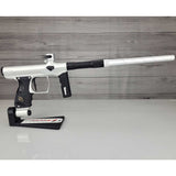 Right side USED Shocker Era Silver black paintball marker in a stand on a woodgrain background.