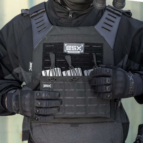 Front of black BSX Plate Carrier LC  for airsoft and paintball with mags on a person dressed in tactical gear and black gloves