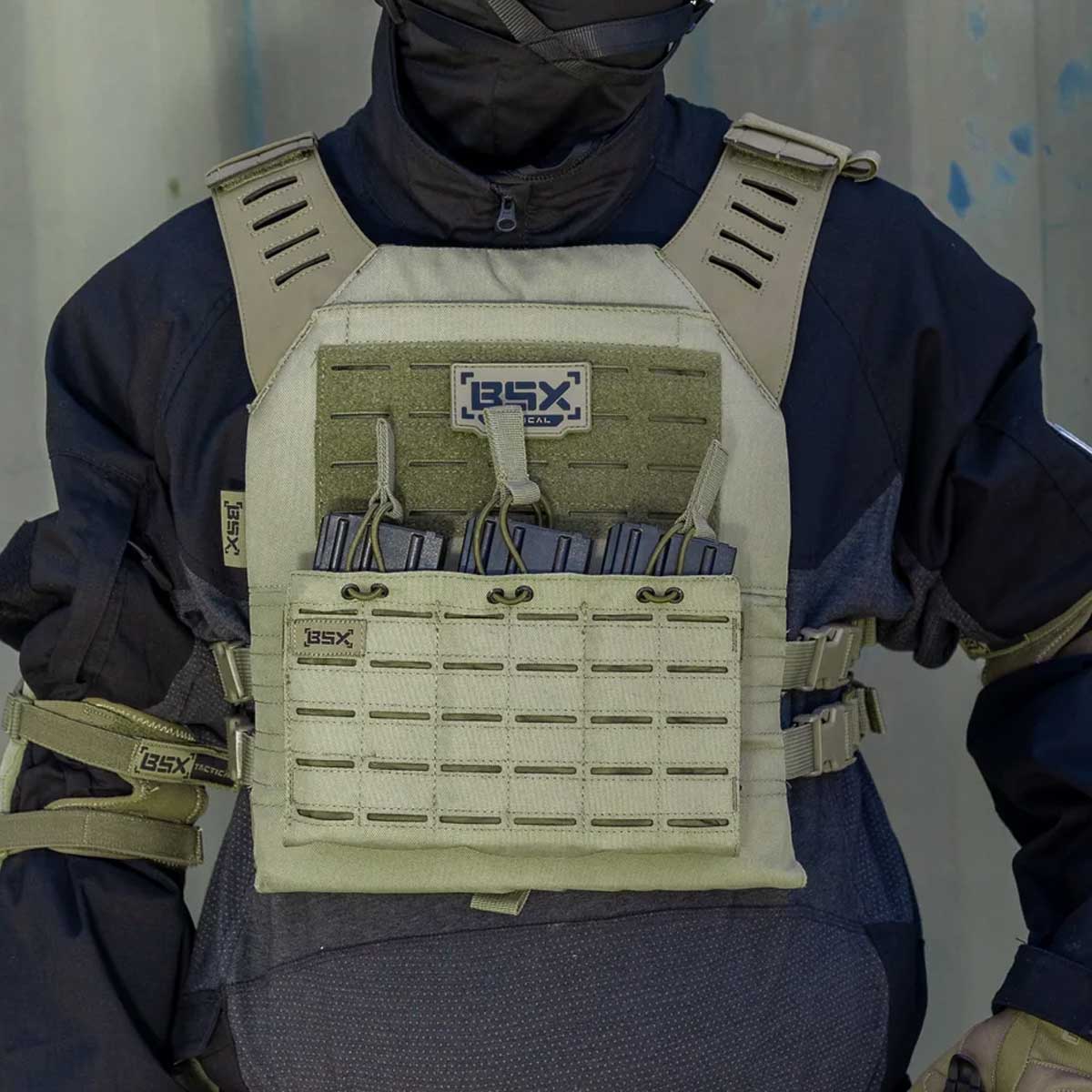 Front of olive green BSX Plate Carrier LC  for airsoft and paintball with mags on a person dressed in tactical gear and black gloves