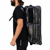 Black green and grey camo print with white logo HK Army Paintball Expand 75L Roller Gear bag Shroud Forest on a person on a white background