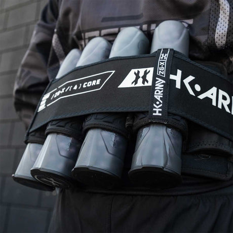 Person wearing a paintball pack with HK Army Apex 150 Round Paintball Pods 6 Pack Light Smoke on a dark background