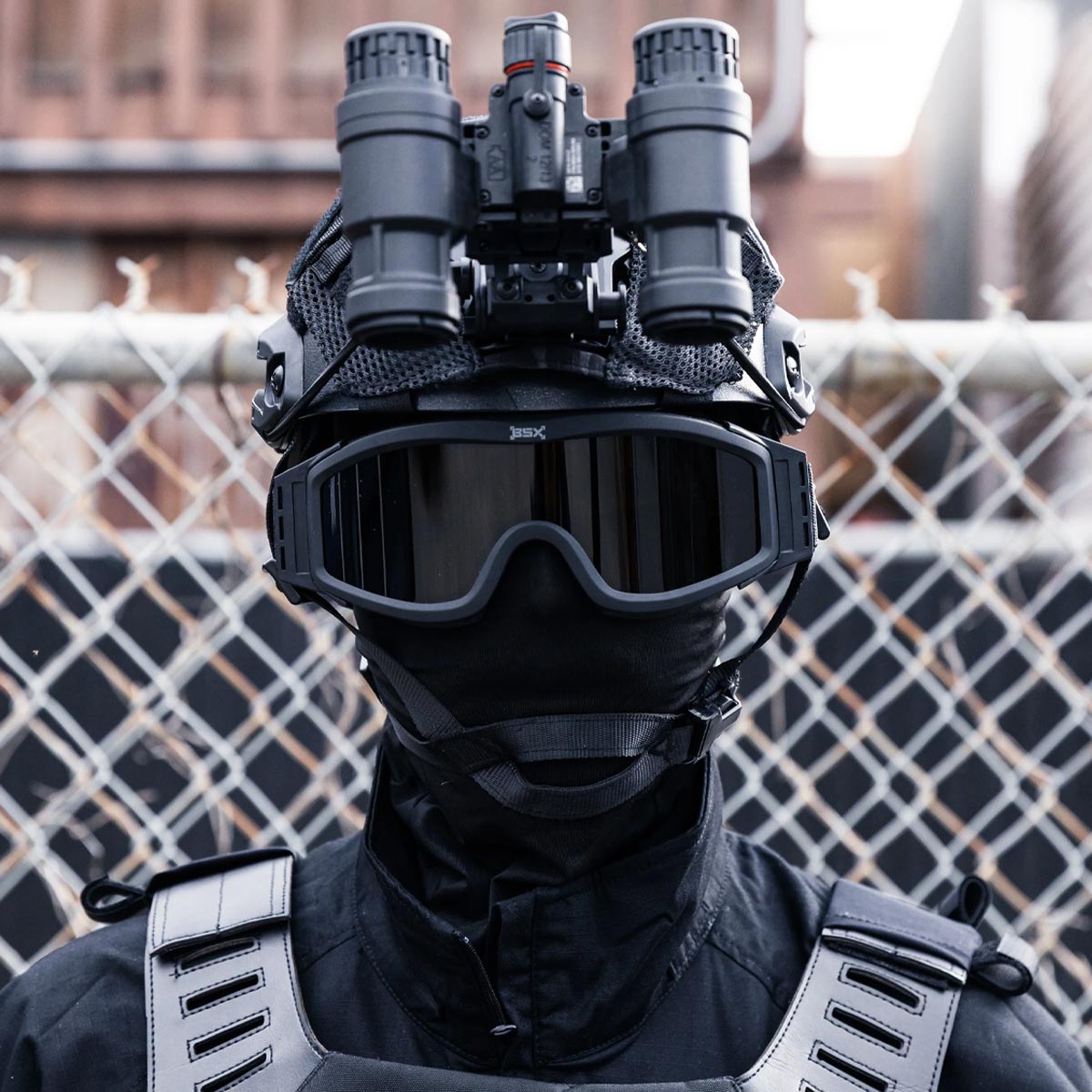 HK Army BSX Tango Airsoft Thermal Goggle with Multiple Lens shown with smoke lens installed on a person dressed in black tactical attire.