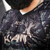 Close up padded chest and neck Black green and tan HK Army HSTL Jersey Jungle Camo on a white background