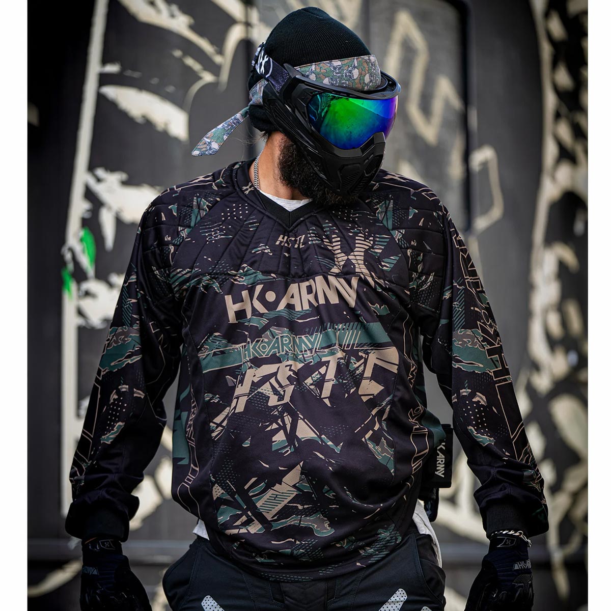Black green and tan HK Army HSTL Jersey Jungle Camo long sleeve on a person on a busy background