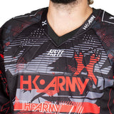 close up neck and chest Red, black, white and grey HK Army HSTL Lava long sleeve Jersey on a person