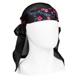 Front of HK Army Headwrap Blossom Black pink flowers on patterned headscarf on a mannequin head against a white background