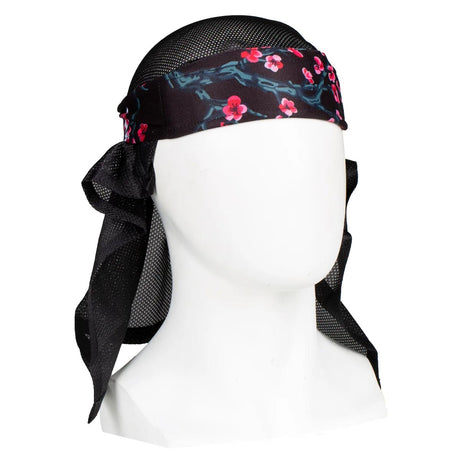 Front of HK Army Headwrap Blossom Black pink flowers on patterned headscarf on a mannequin head against a white background