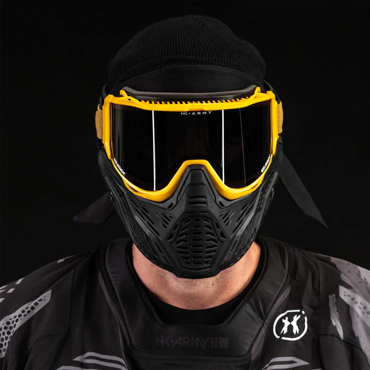 Front view of person wearing HK Army RMX Thermal Paintball Goggles Black yellow Gold with smoke lens on a black background