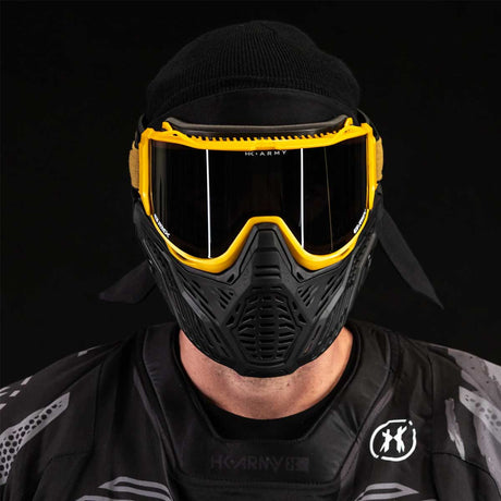 Front view of person wearing HK Army RMX Thermal Paintball Goggles Black yellow Gold with smoke lens on a black background