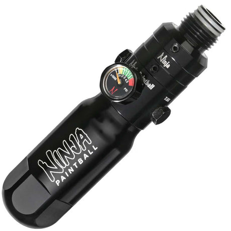 A black anodized aluminum Ninja Pocket Bottle 4500psi Reg Tester with white 'NINJA PAINTBALL' branding installed on a Ninja reg shown on a plain white background.