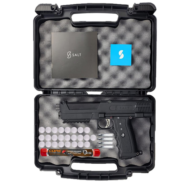 Salt Supply S1 Pepperball Pistol black in a foam lined case with glass break rounds, co2 cartridges and a tube of pepper projectiles on a white background