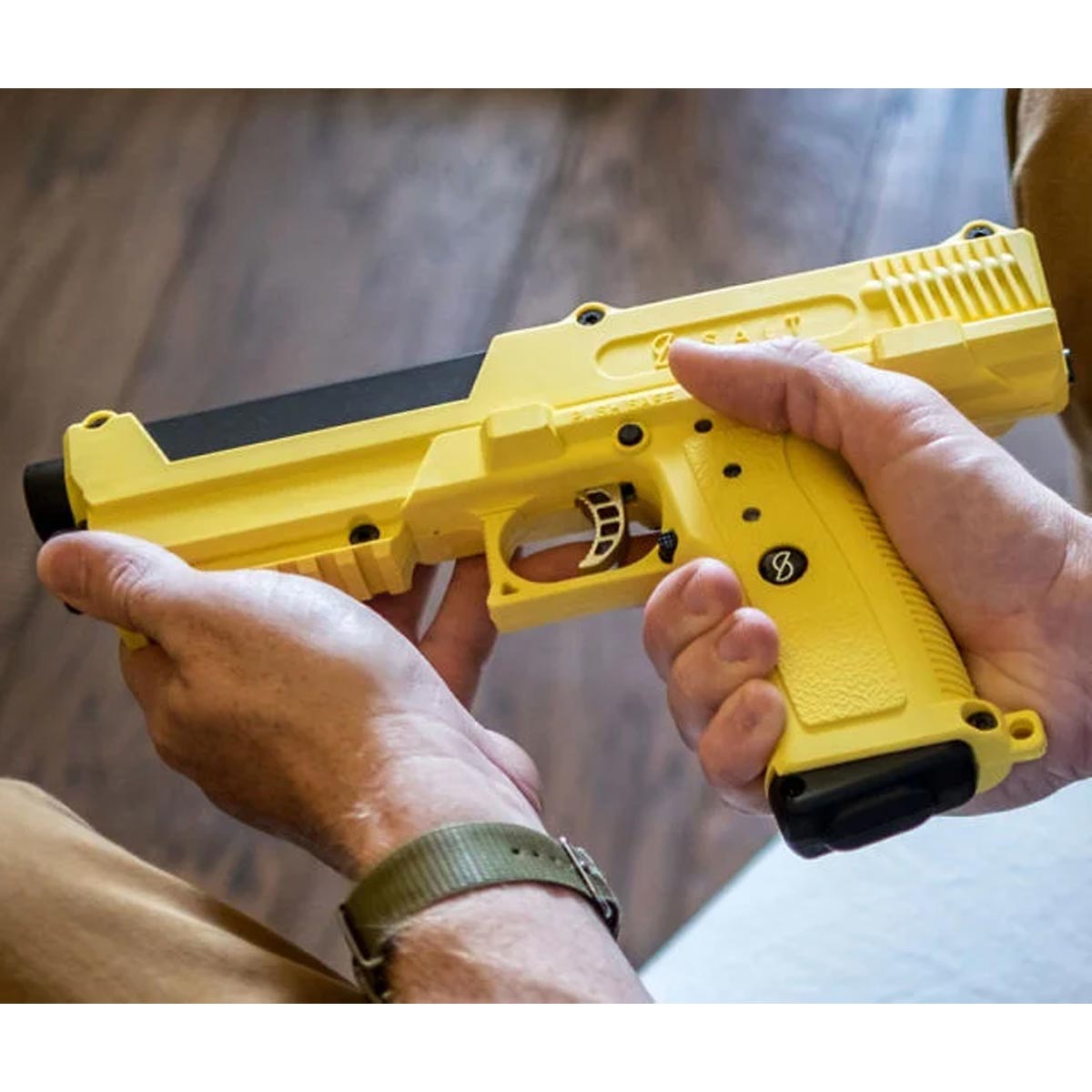 Yellow Salt .68 Caliber Self Defense launcher in a persons hands