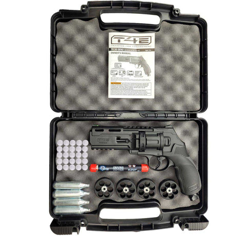 A open black case containing an Umarex T4E TR50 Gen 2 Revolver Pistol .50 Caliber Self Defense launcher with 4 extra mags, 4 co2 cartridges, 10 pepper rounds and 25 glass break rounds all on a white background.