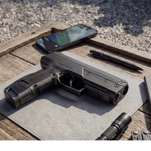 Byrna CL-XL black left side view with 7 round magazine and 12 gram co2 on a wood table