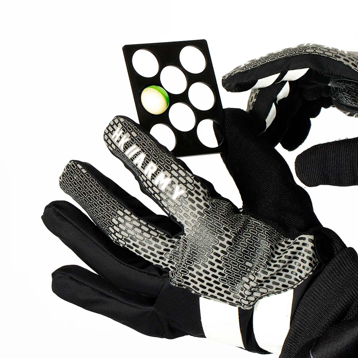plastic HK Army Reload Paintball Hauler sizer being held by gloved hands on a white background.