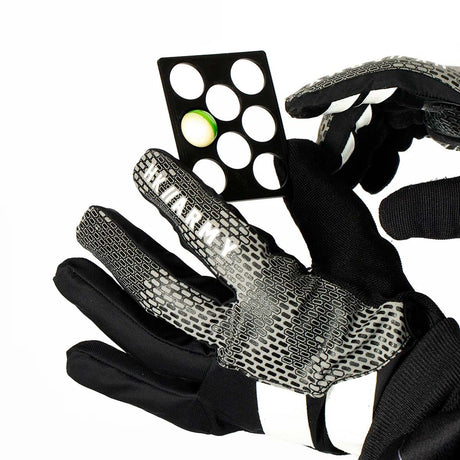 plastic HK Army Reload Paintball Hauler sizer being held by gloved hands on a white background.