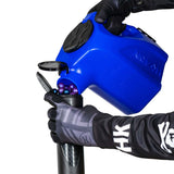 Blue plastic HK Army Reload Paintball Hauler Caddy for loading paintballs into pods and hoppers being used to fill a pod.