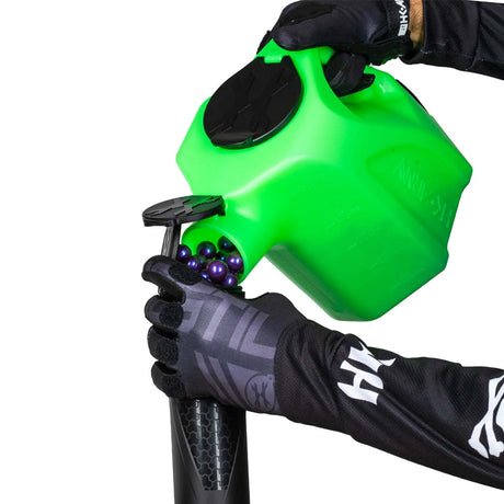 lime green plastic HK Army Reload Paintball Hauler Caddy loading paintballs into a pod.