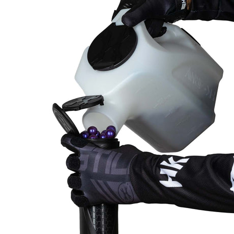 White Clear plastic HK Army Reload Paintball Hauler Caddy shown loading paintballs into a pod.