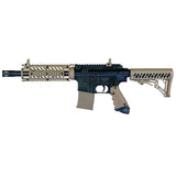Left side Tippmann TMC black tan paintball marker with banking dummy magazine on a white background